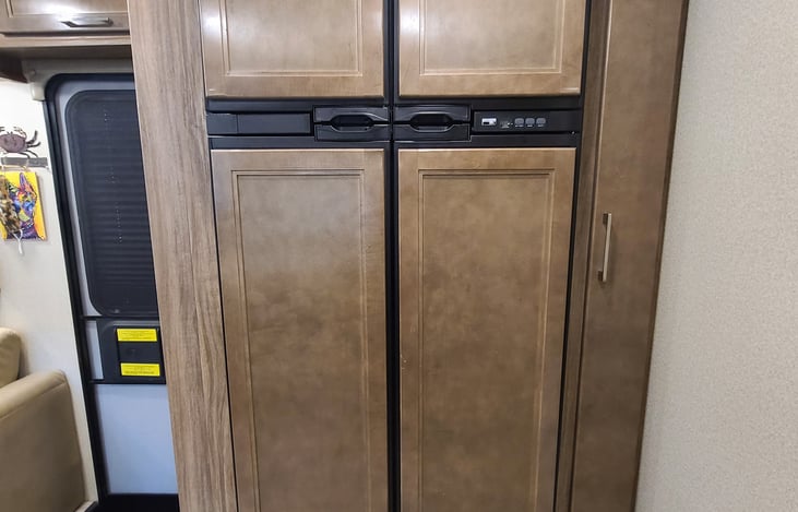 A residential size fridge.  Load up all your goodies prior to hitting the road.  Runs on either propane or AC power.