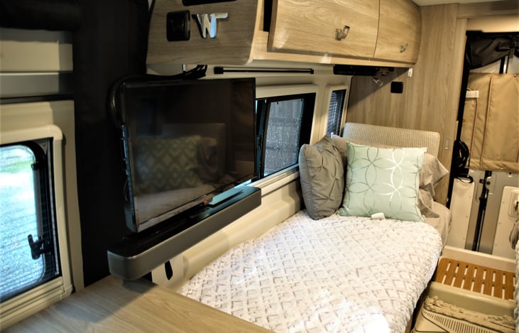 View of one of the beds. The tv swivels around and so that you can see it from outside.