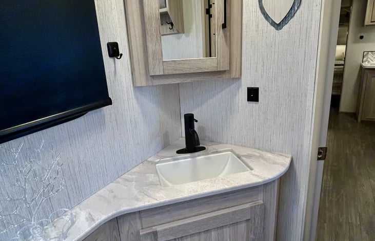 Bathroom sink with cabinet space for toiletries.