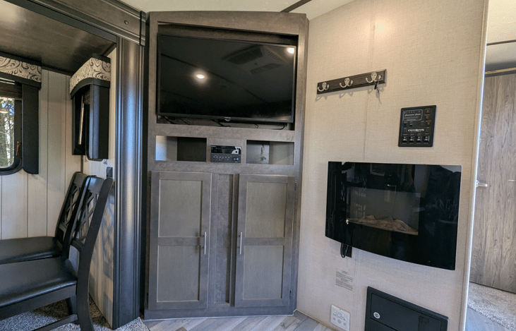 Very spacious living area offers a cozy retreat with theater-style recliners, a premium entertainment system, fireplace, TV, dinette and well-equipped kitchen.