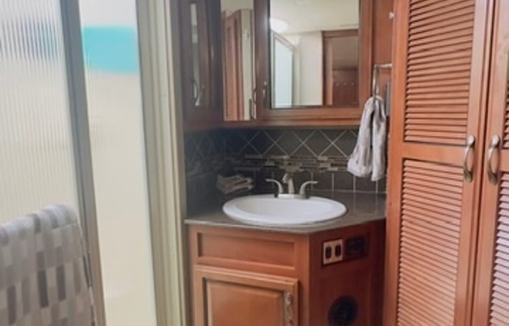 The vanity area has a large lighted sink area to spread out your toiletries.