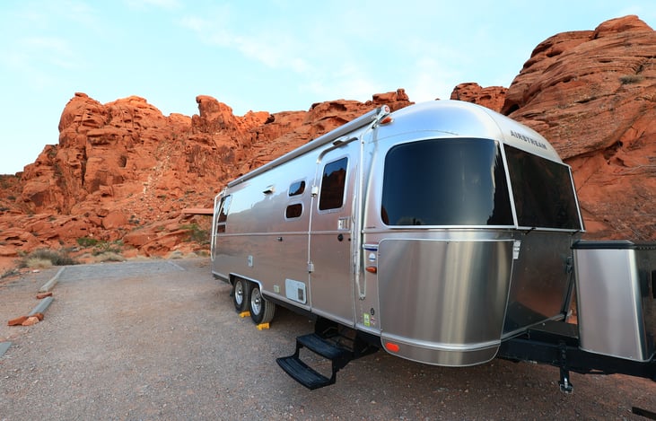 Full length awning on passenger side. Also features smaller awnings on rear and driver side to shade windows.