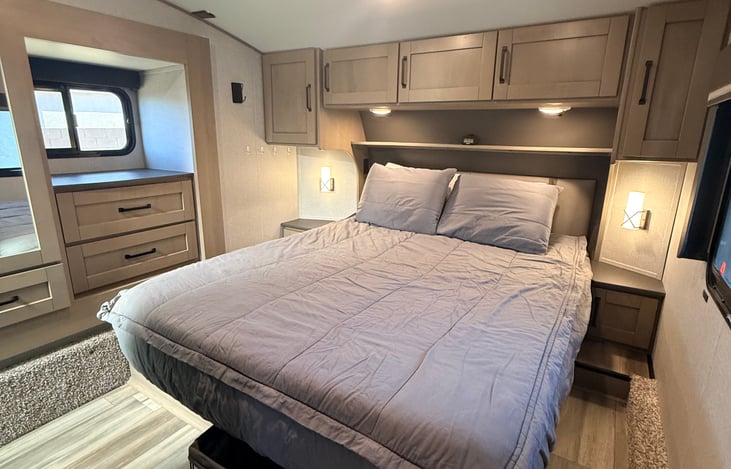Main bedroom with bedside tables, reading lights and charging outlets.