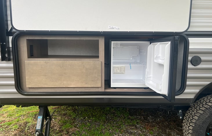 mini fridge and storage on the left of the door