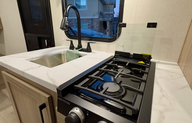 2 burner range with glass top for additional counter space.