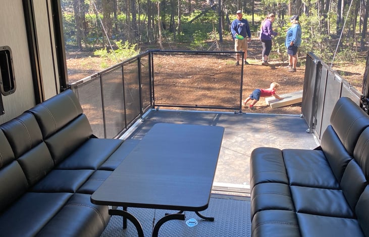 Garage area with loading ramp that also can be used as a patio. Also pictured is the couches that fold down into a bed. *not pictured bunch bed above