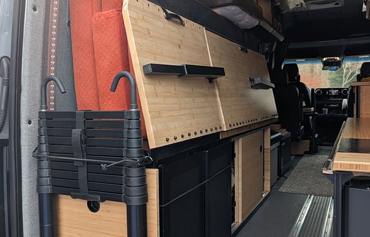 Bed folded away for open storage or movement