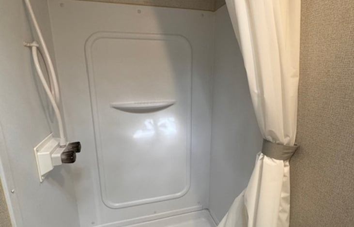Shower clearance is ample up to about 5'9", and adequate up to about 6'1", and not ideal for 6'1"+ (owners personal opinion)
