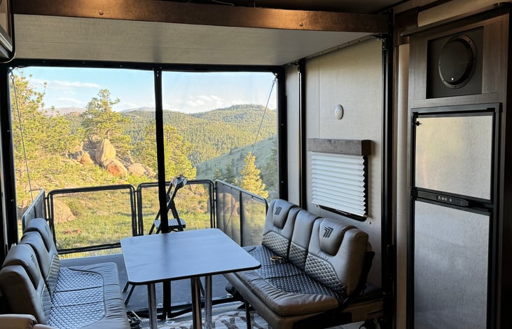 The dining area also doubles as the rear sleeping area. The seating converts to a full width bed and there is a full size bed above the dining area that can be lowered for additional guests.