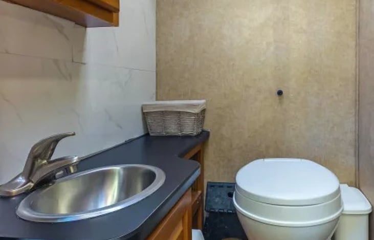 Full private bathroom with shower, sink, and toilet — enjoy the comfort of home while traveling or camping off-grid at Burning Man.