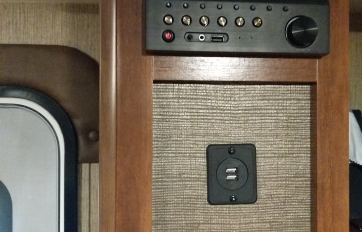 Radio, Indoor/Outdoor speak controls, Dvd Player, Bluetooth, and USB Port for charging.