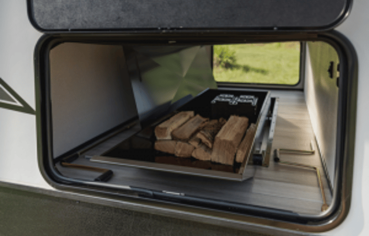 Pull out drawer in basement storage is perfect for firewood.
