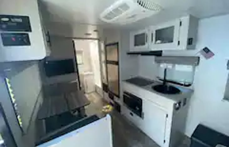 Kitchen with oven, stove, sink refrigerator/freezer, and microwave
