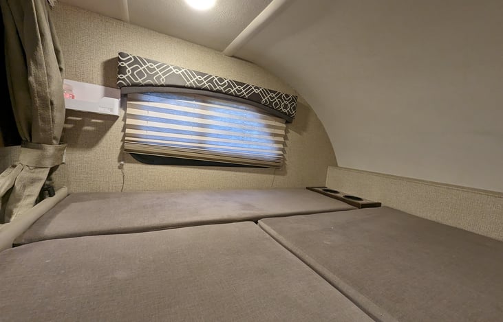 huge bunk-over-cab with storage, cupholders and curtains for privacy.
