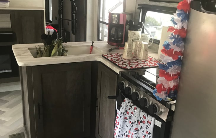 Kitchen with stove, oven, refrigerator and freezer. Dishes and pans are included for use with rental.