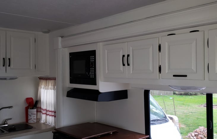 Remodeled throughout. The 3-burner propane stove, oven, double bowl sink, and microwave make for easy kitchen meal prep.