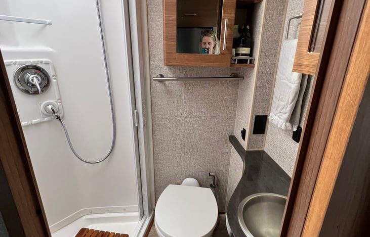 Bathroom with shower, toilet and sink areas