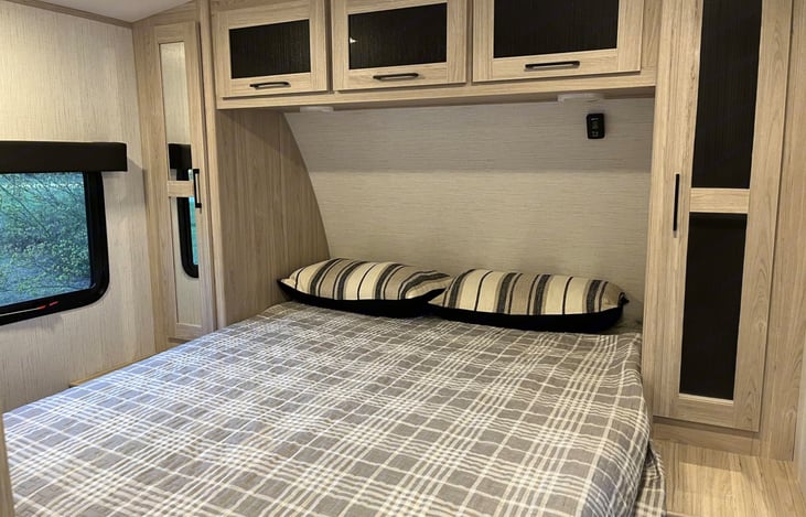 Private bedroom with Queen bed and ample storage.