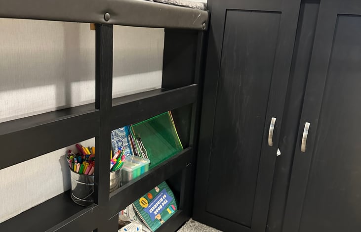 Bookshelves under one of the bunk beds have fun things for families to do and a place to keep your belongings.