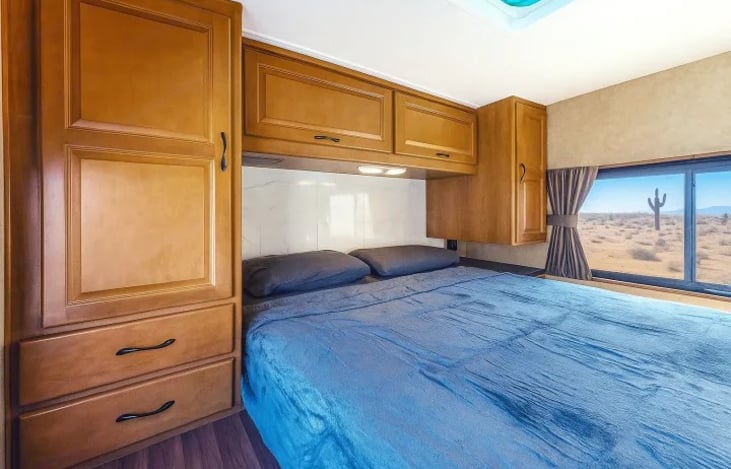 Private queen bedroom with plenty of storage — cozy retreat for couples or families enjoying their Las Vegas motorhome adventure.