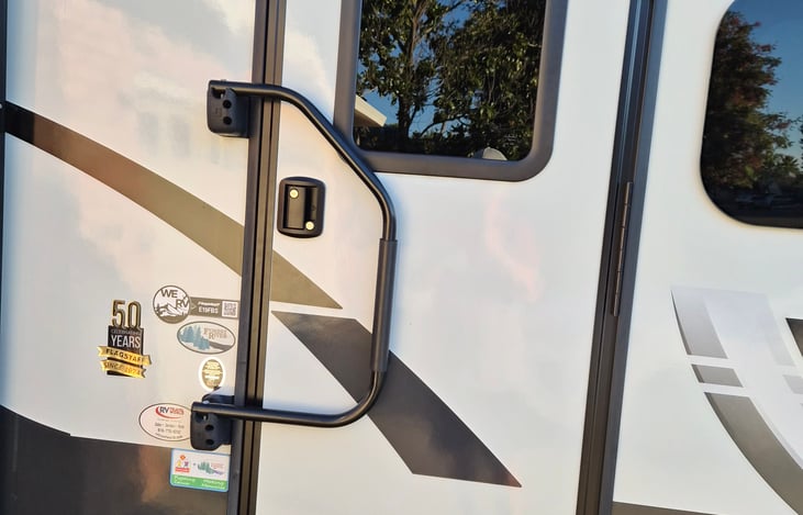 Front door with screen door and pull down steps.