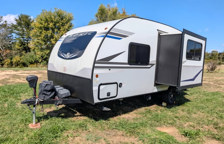 Easy-tow 2022 Venture Sonic Lite (3,600 lbs)! Features off-grid solar, all-terrain tires, slide-out, spacious rear kitchen, queen bed & power awning. Perfect couple's getaway for any adventure!