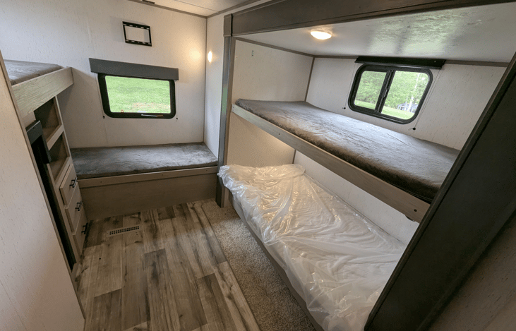 Cozy private bunkhouse in the back of the camper sleeps 4. Multiple windows for ample natural light.