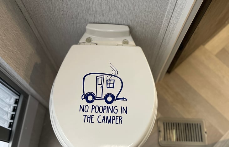 Domestic Toilet.  

Follow the advice on the lid.  You don’t want to poop in the camper…I promise, LOL!