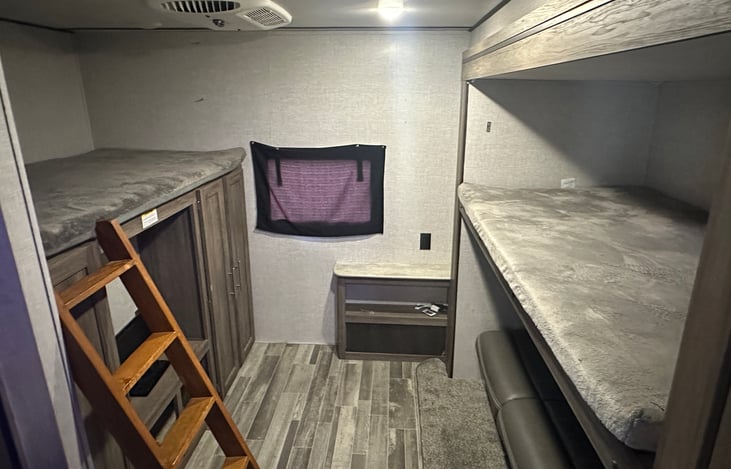 Rear bunk room with two bunks and fold down couch that turns into bunk