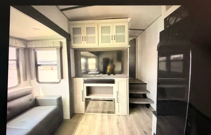 Living area with side-by-side fridge.