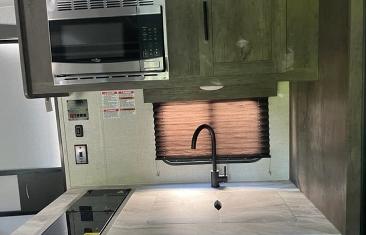 Glass cover on stove top burners for additional countertop space.