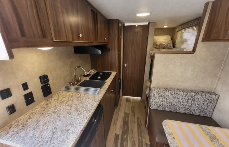 Sink stove countertop below the counter is a fridge