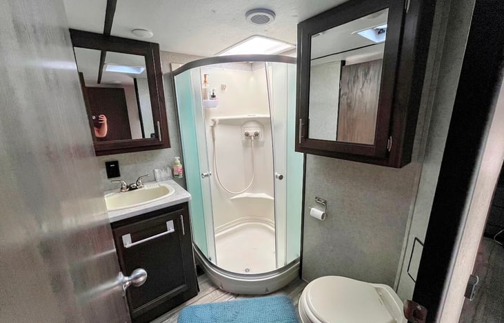Bathroom with shower, sink, and toilet.