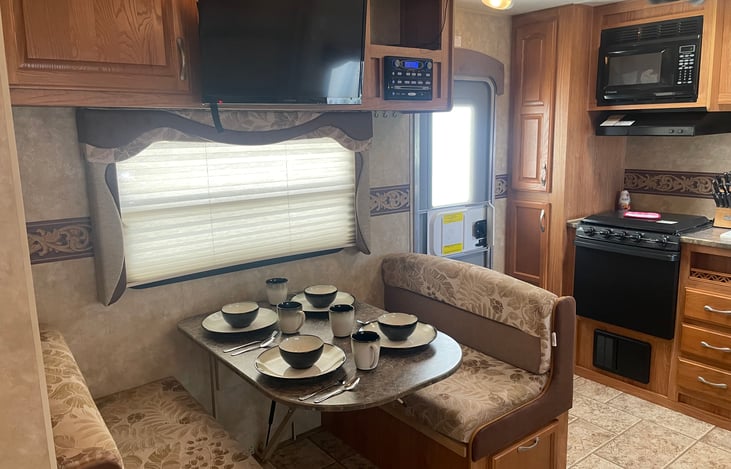 Dinette folds to a bed. Also featured is TV, CD player, indoor/outdoor speakers and the drawer beneath the bench is filled with board games for every age. A Bible is also provided.