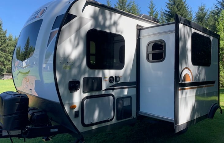 Slide out and fresh water and electric hook ups. Outdoor shower