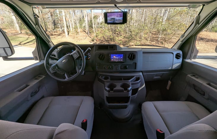 Comfy cabin with touch screen radio and rear view mirror with cameras.