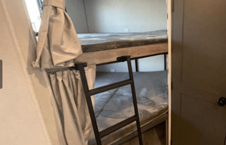 Oversized Bunks - Bottom bunk folds up for storage through rear bunk door.

***Rear Bunk Door Deadbolts for Safety***