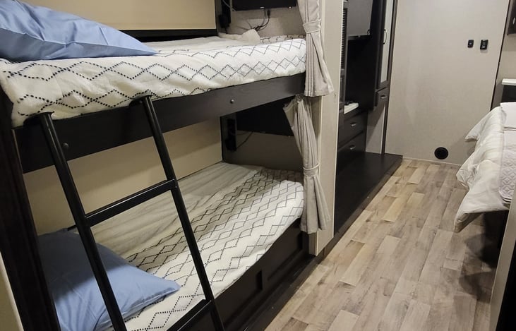 Slide-out bunks have ladder, please be careful when placing to preserve the wood finish.  Walkway to Master Bedroom.