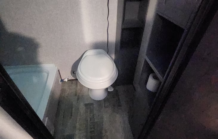 Ample storage space in the bathroom for essentials.  Hot shower with soap & shampoo dispensers.  No little bottles rolling around under your feet or walks to the not so clean shower house in the heat