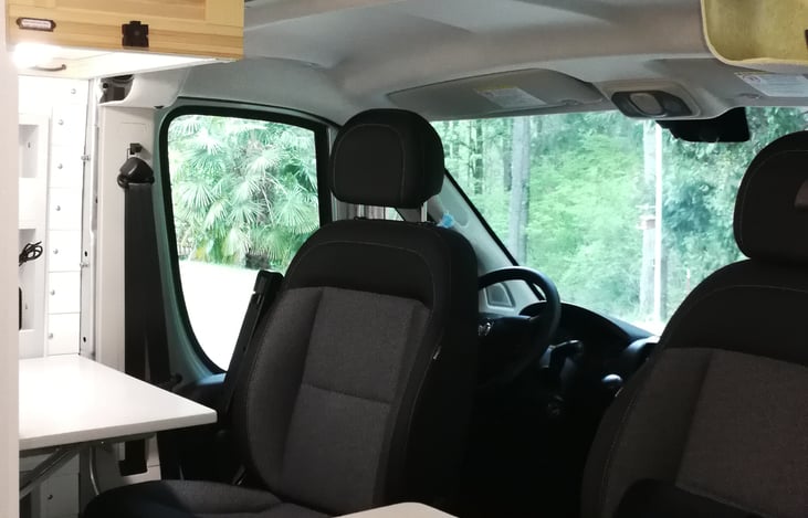 Two front seats can turn around with tables for eating and office