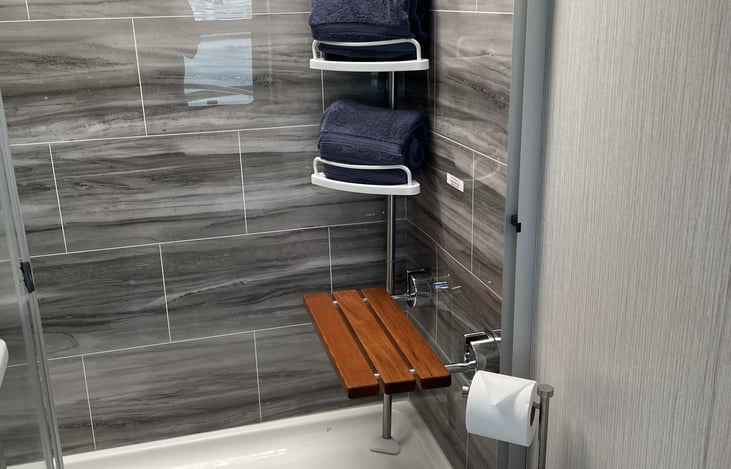 Luxury Bath & Bed: A spacious master suite paired with a premium walk-in shower, complete with fresh, plush towels and signature soaps.