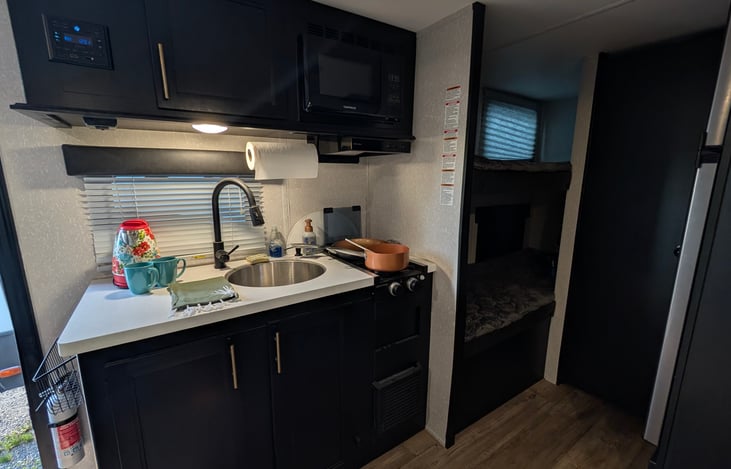 Upgraded quartz countertops; kitchen comes with coffee maker and electric kettle, and cooking basics; large fridge with spacious freezer