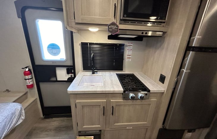 Sink, LP stove, microwave, fridge, and freezer