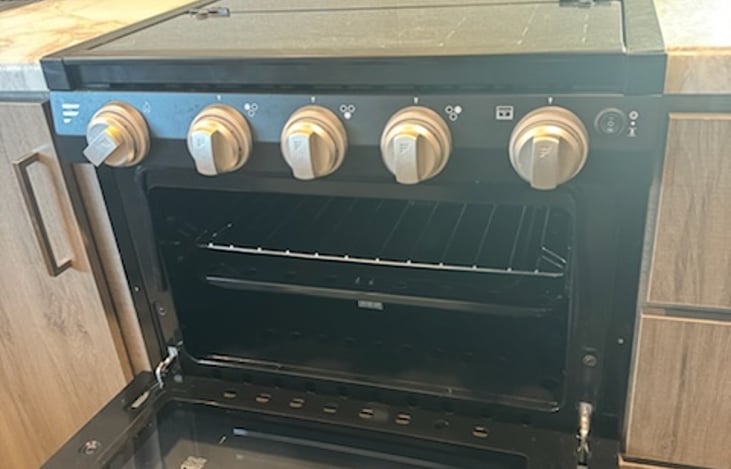 three-burner stove top with full function oven, electric ignition.