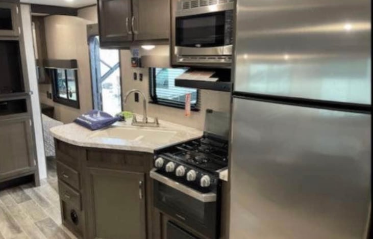 Kitchen includes refrigerator, microwave and cooktop/oven.  There is a sonic ice maker which is not pictured here.