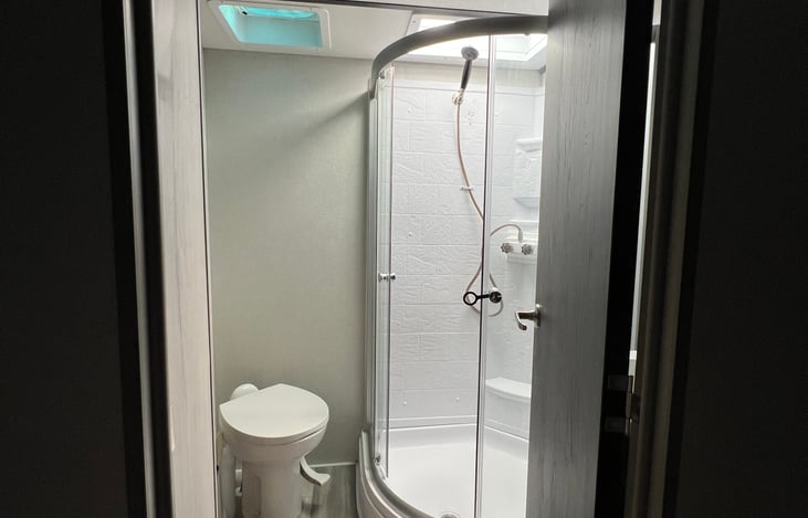 Master bath / shower with fan.  Toilet bowl is porcelain.