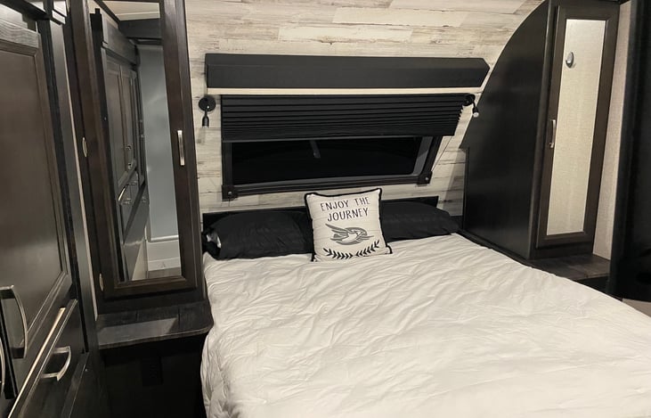 Master Bedroom with Queen Size bed, and storage on both sides.  Window over bed allows for views of stars at night!