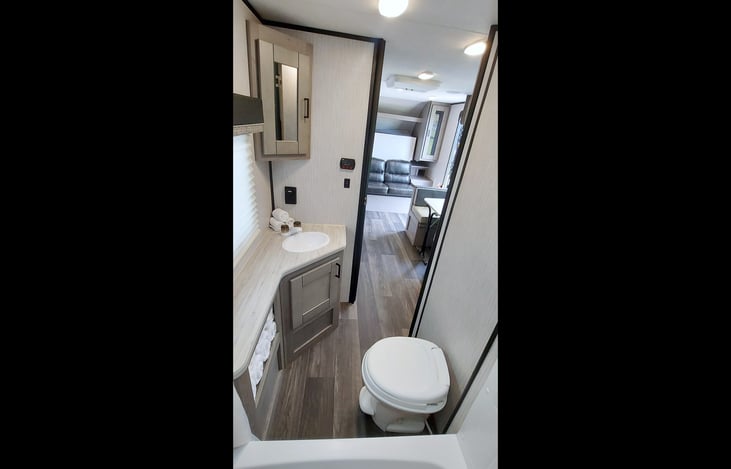 Bath: Shower, tub, toilet, sink, towel shelving, medicine cabinet, under sink cabinet, 2-plug electrical outlet.