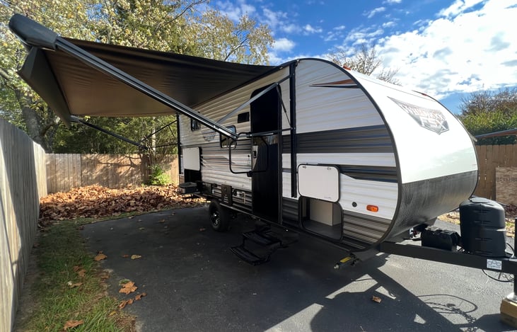 Exterior showing front entry with full size awning extended