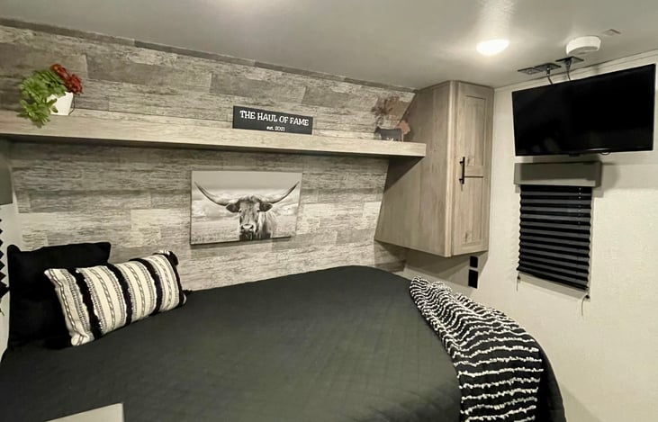 Queen bed with 3" mattress topper for comfort.
TV